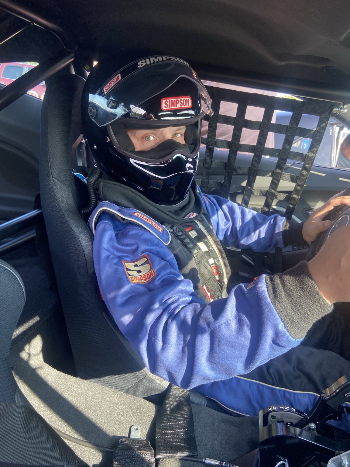 Glenn suited up in his race car